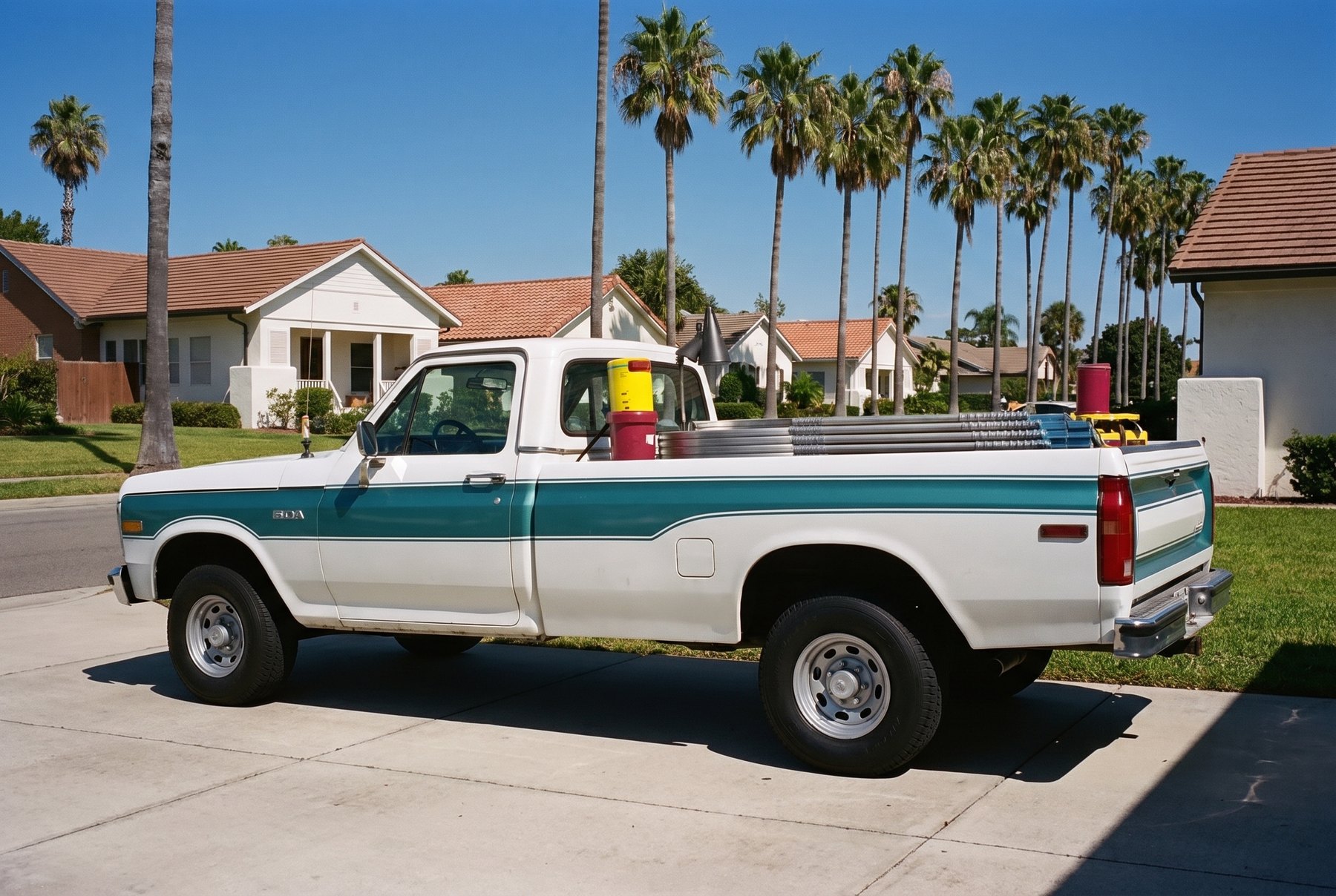 The Pelican truck between route stops, poles and buckets stowed in the bed